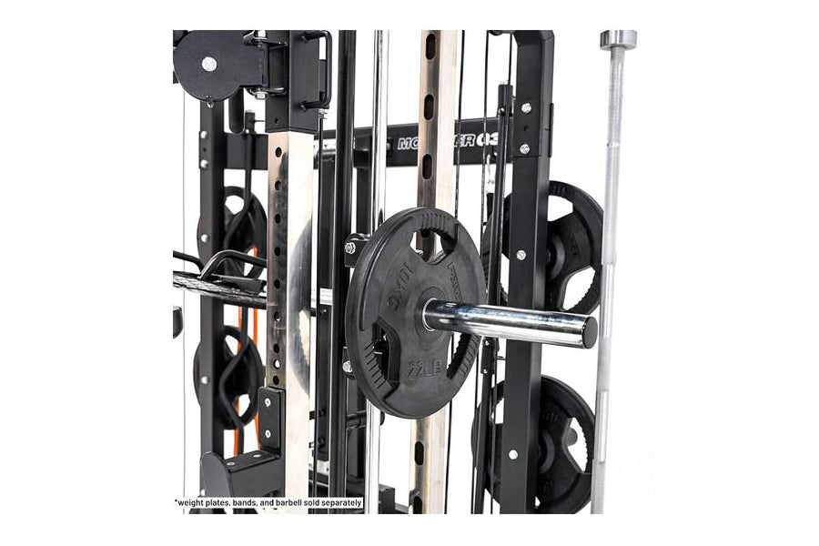 Black and silver multi-function gym machine with weight plates on chrome barbell, featuring cable crossover and smith machine