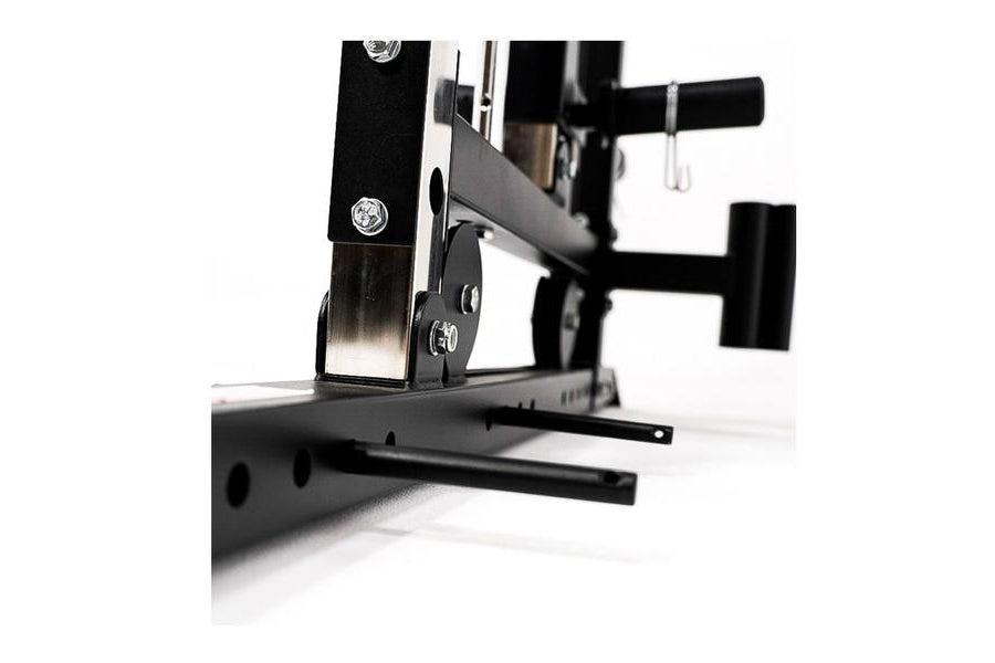 Black and silver dual cable functional trainer with Smith machine frame, adjustable pulleys, and weight stack on white backgr