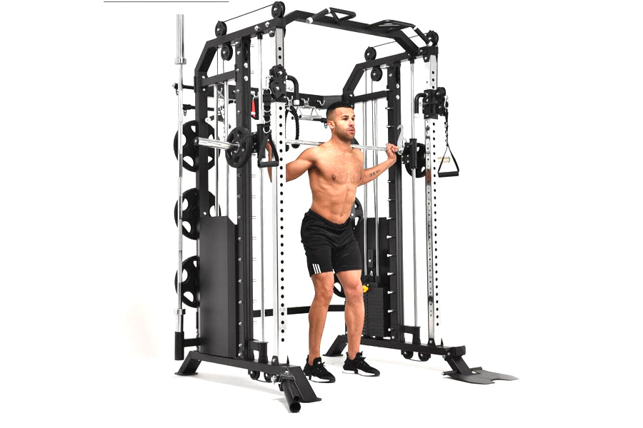 Black and white multi-functional home gym cable crossover machine with smith bar, used by shirtless male model in black short