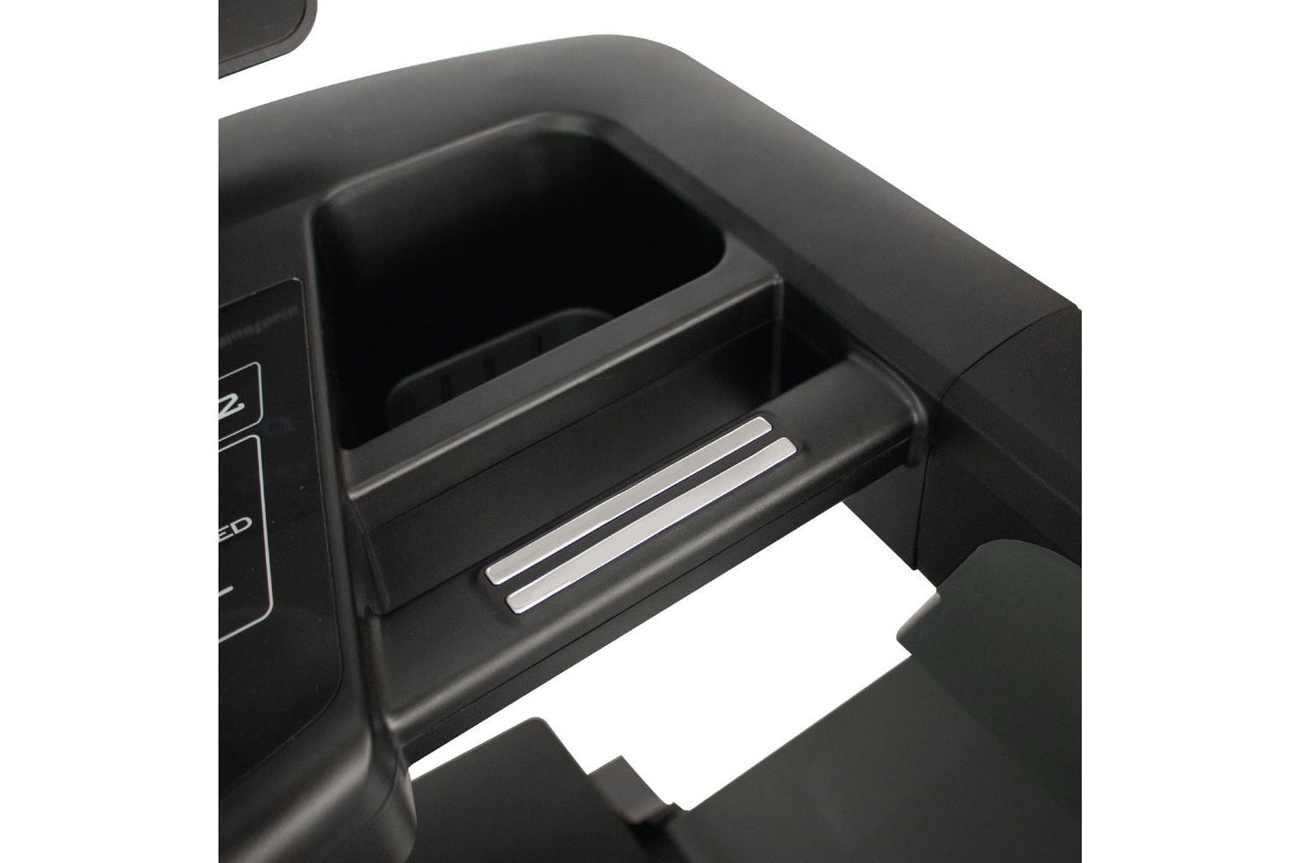 Black treadmill cup holder and storage compartment with chrome accents, open drawer detail
