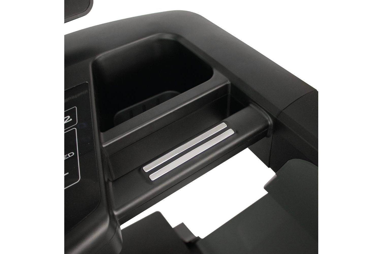 Black treadmill cup holder and storage compartment with chrome accents, open drawer detail