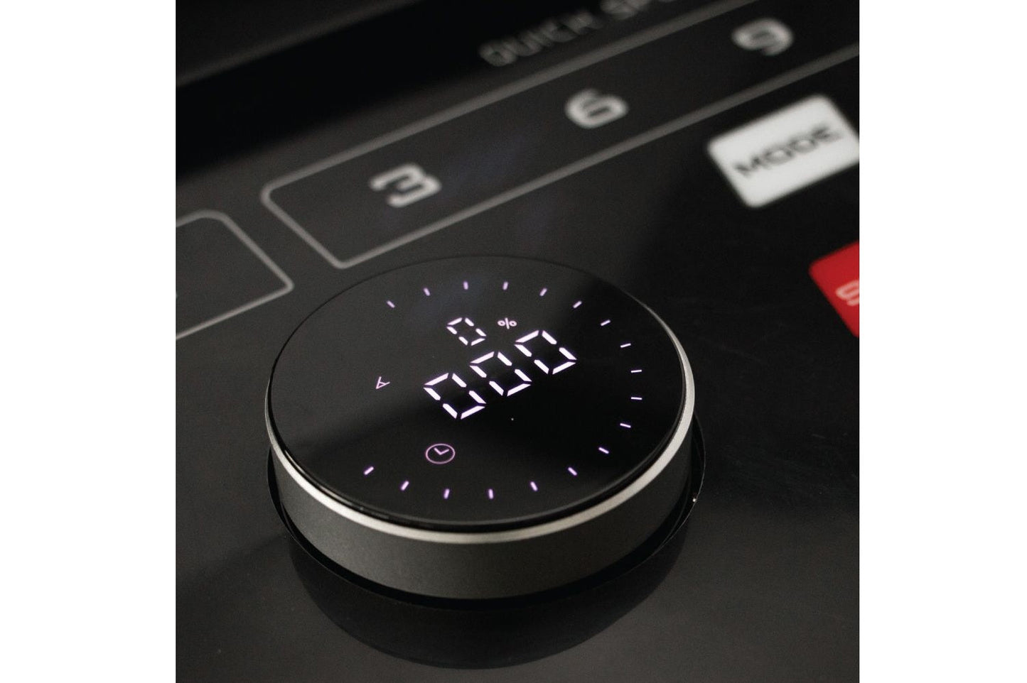 Round black digital timer with white LED display showing time, mounted on treadmill control panel with buttons and red emerge