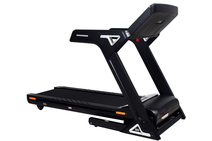 Black heavy-duty folding treadmill with digital touchscreen console, orange accents, and wide running deck on white backgroun