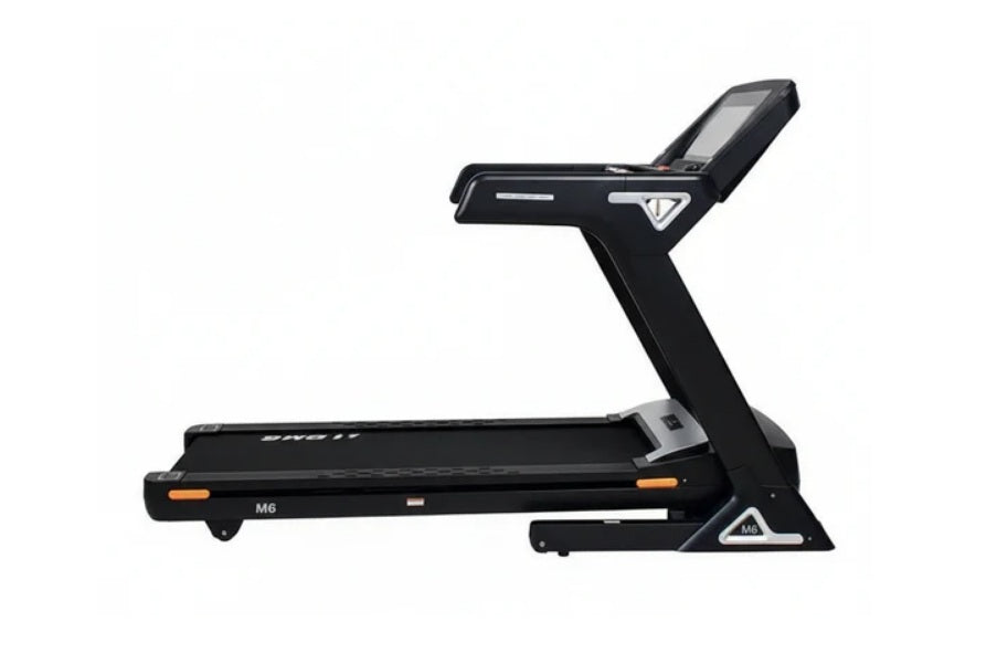 Black folding treadmill with digital touch console display, orange accent details, and model M6 designation on white backgrou