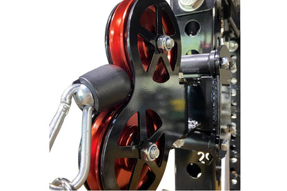 Warrior cable crossover pulley system with dual red and black wheels mounted on dark steel frame with metal lever handles and
