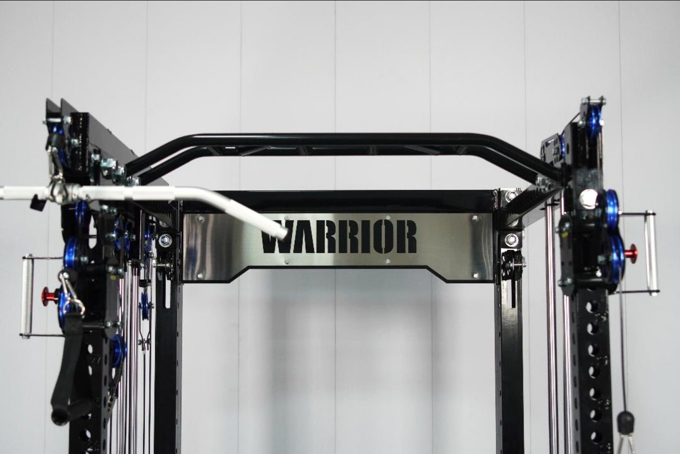 Warrior 3.5 cable crossover pulley power rack with black frame, blue pulleys, and stainless steel center plate on white backg