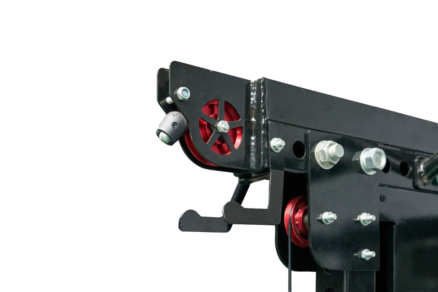 Black steel cable crossover pulley system with red wheels and metal bolts, mounted on white background
