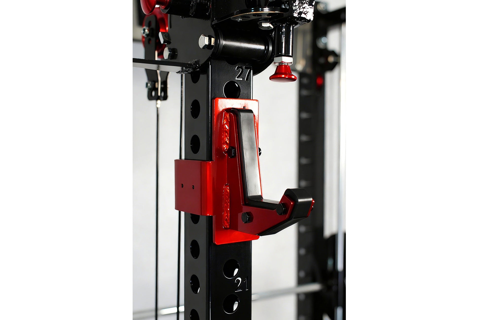 Red and black cable crossover pulley system mounted on tall frame with dual weight stacks and adjustable pulleys