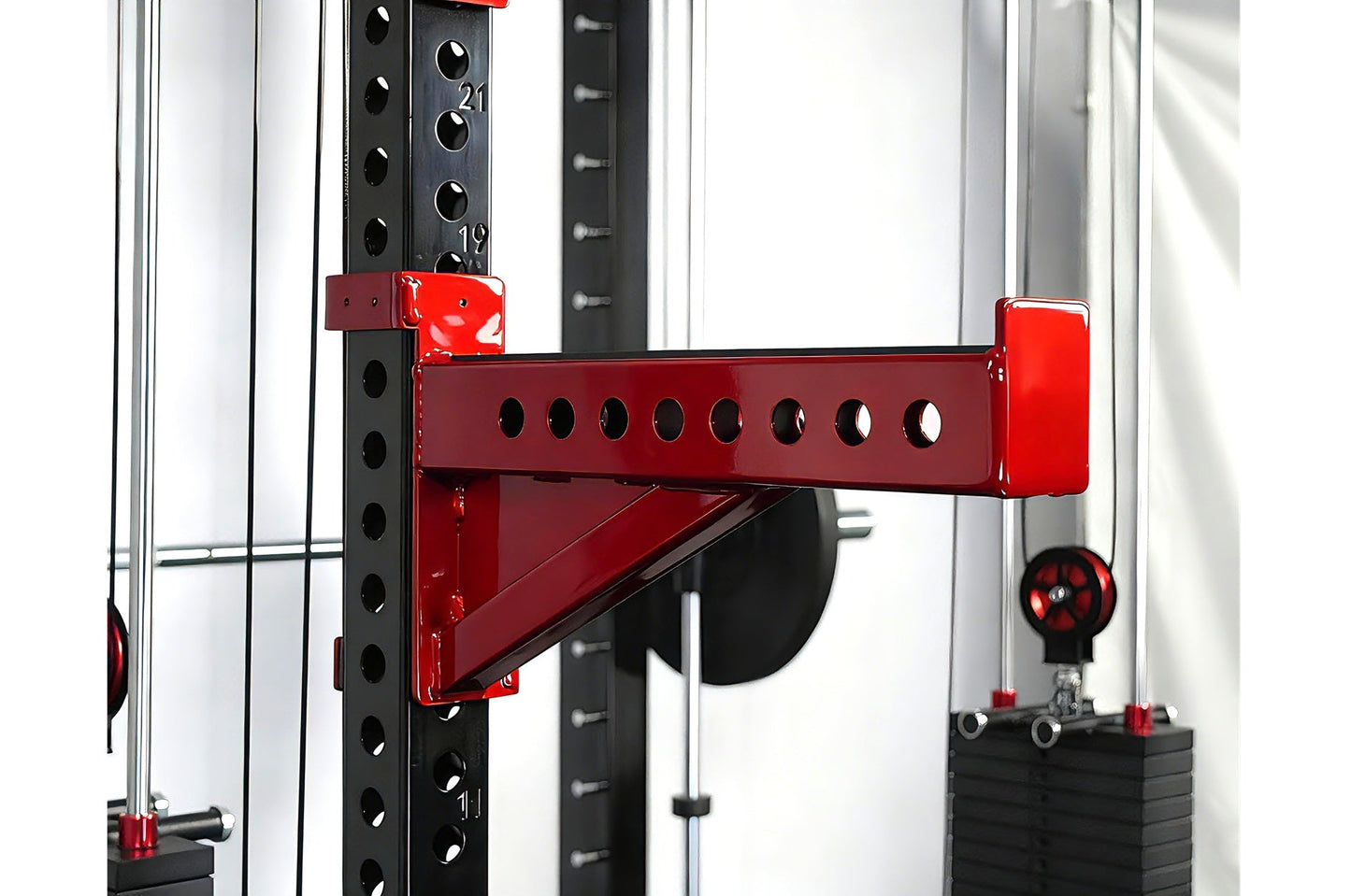 Red and black cable crossover pulley attachment mounted on black power rack with perforated uprights and numbered markings
