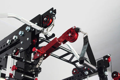 Black and red cable crossover pulley system with silver aluminum frame, dual adjustable pulleys, and black straps on white ba