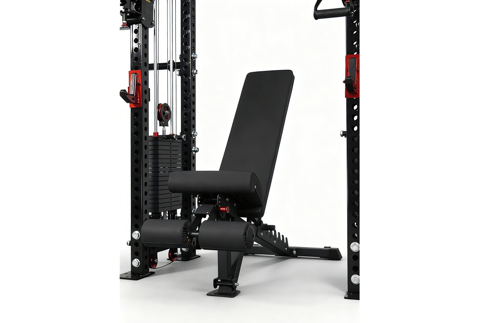 Black and red cable crossover pulley power rack with adjustable black padded bench and leg extension attachment, on white bac