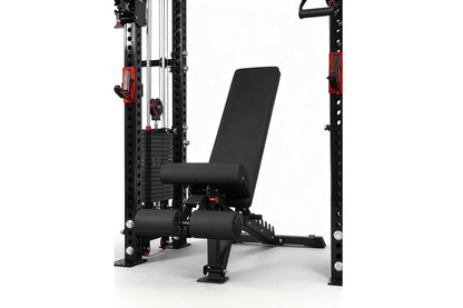 Black and red cable crossover pulley power rack with adjustable black padded bench and leg extension attachment, on white bac