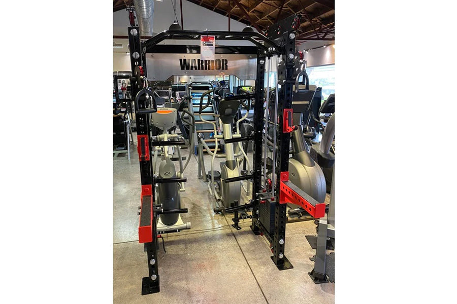 Warrior 2.0 black and red cable crossover pulley power rack with dual weight stacks in gym setting