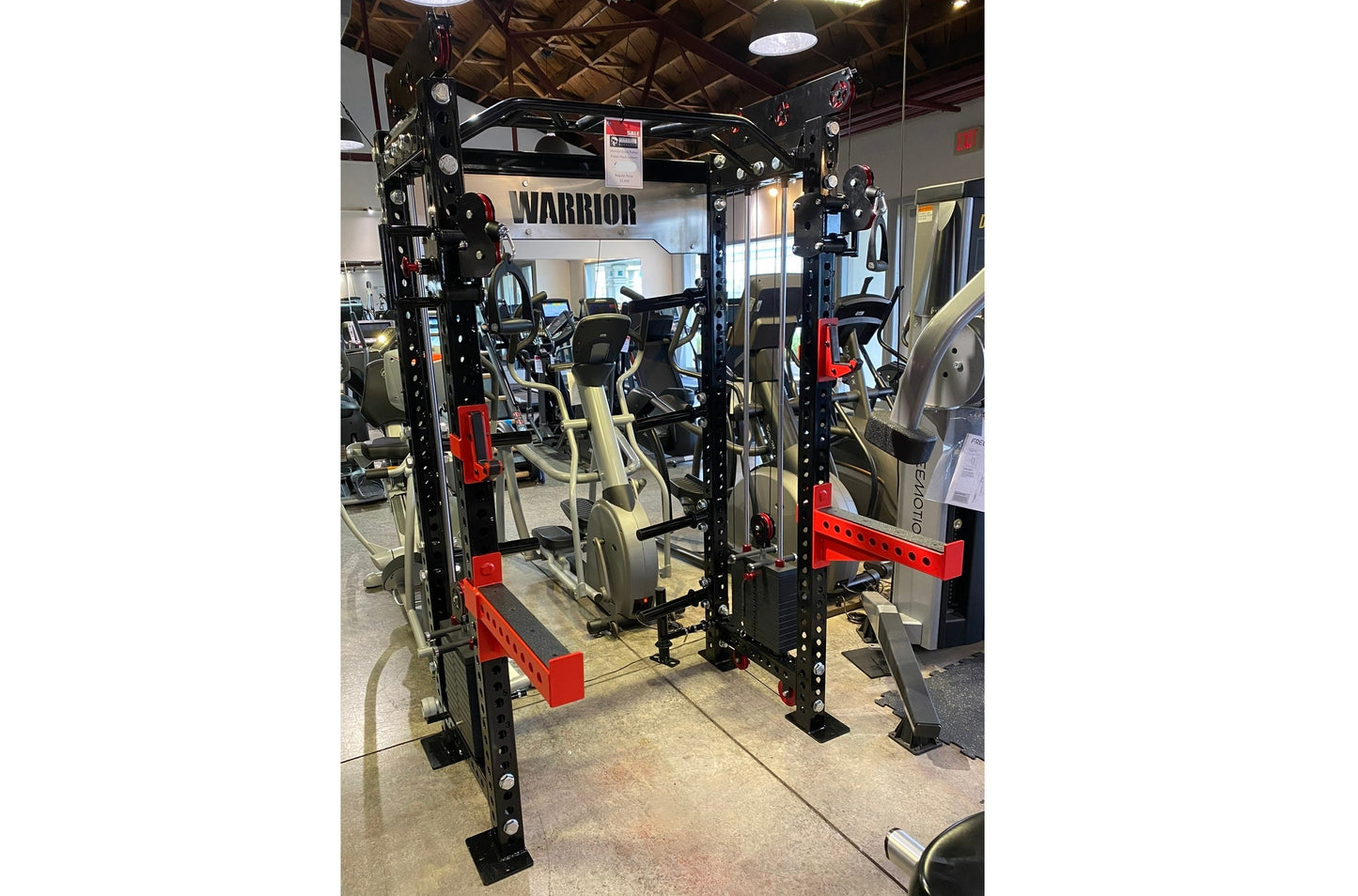 Warrior 2.0 black and red cable crossover pulley power rack with dual stations in gym showroom